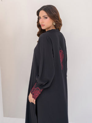 Women black summer outfit ,red motif on back of shirt and embroidery on sleeves cuff in Pakistan.
