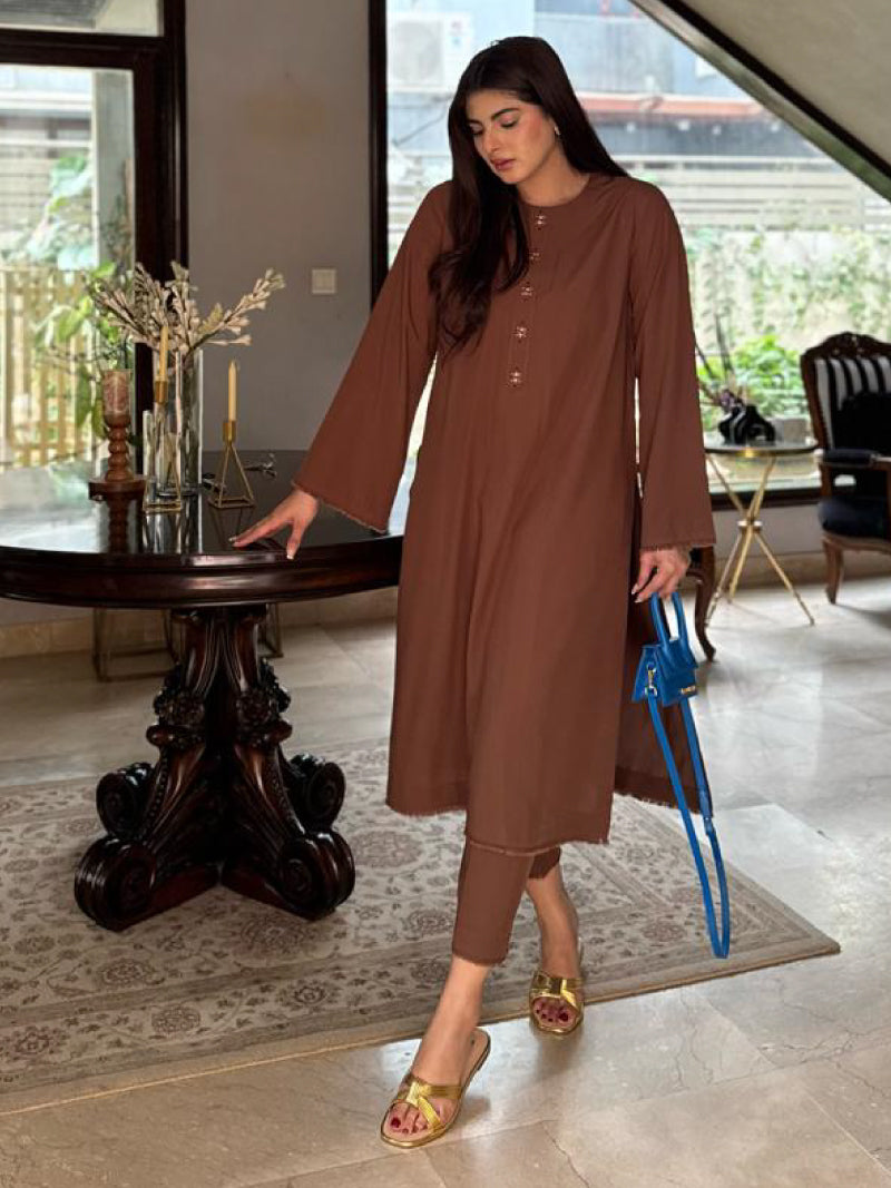 A solid coffee-brown co-ord set wearing by a woman with golden footwear. 