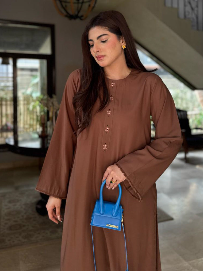 A coffee-brown two-piece women's outfit shot by a renowned, beautiful, and stylish blogger, Misbah Dossani. 