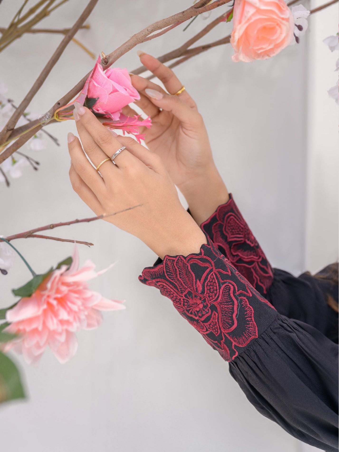 Red floral embroidery on shirt cuff, for women day time outfit.