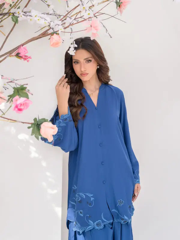 Model wearing royal blue boski linen two-piece outfit with floral cutwork embroidery